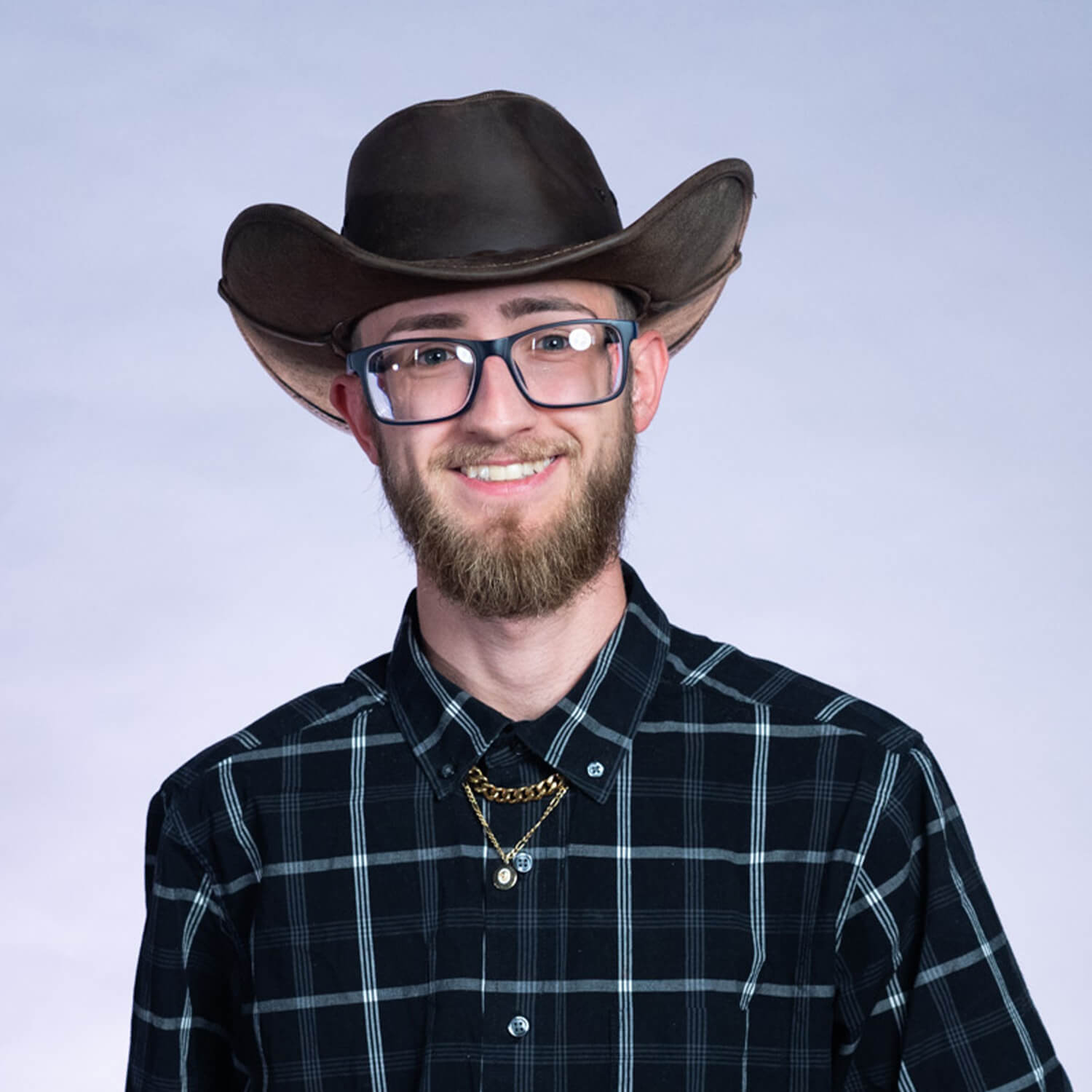 Photo of Mitchell in a cowboy hat